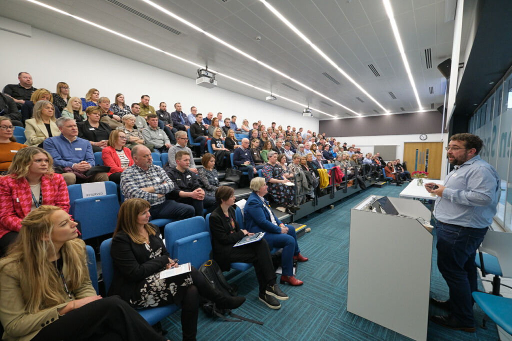 delegates seated in college auditorium